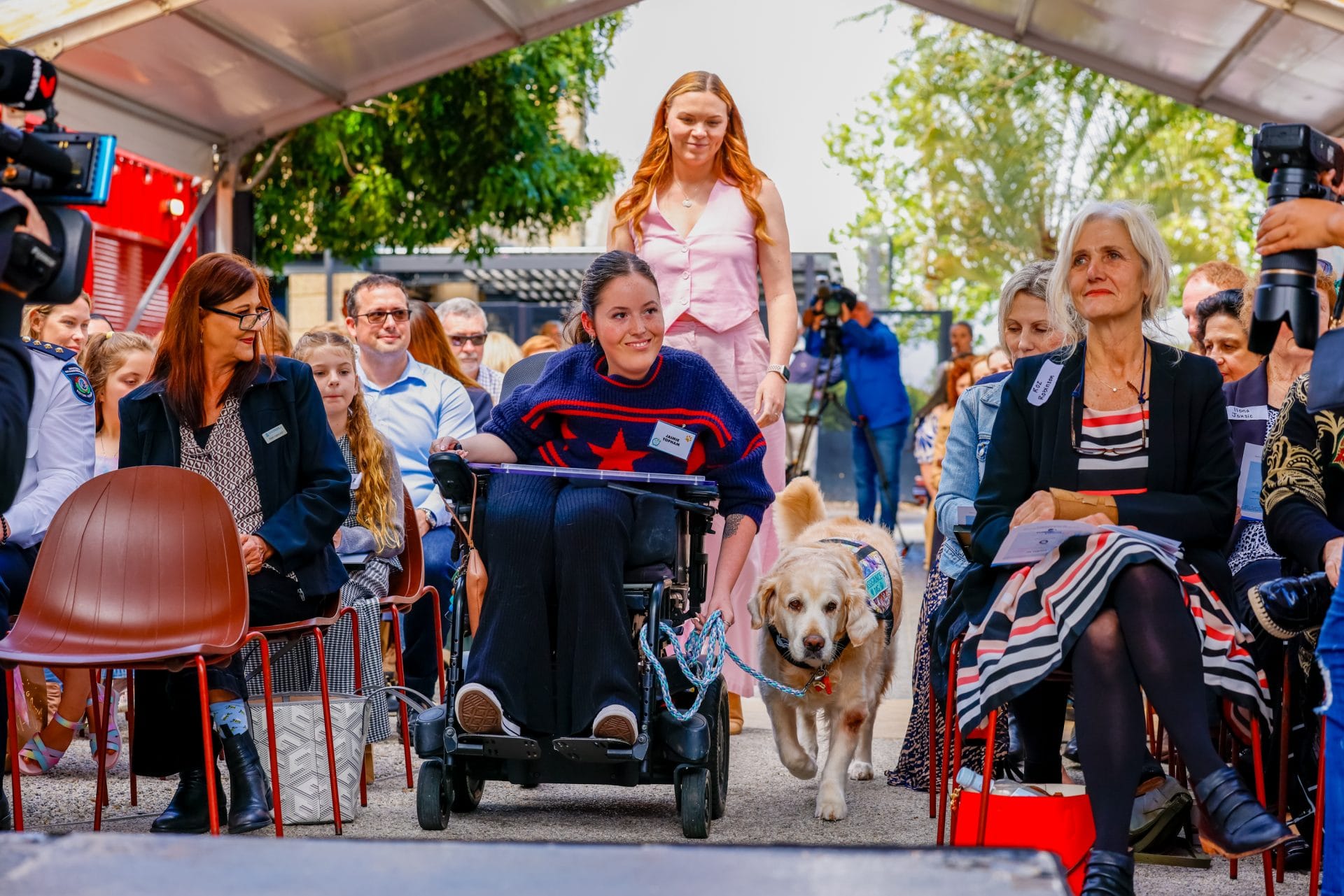Animal welfare awards 2024 Jaime Topham with crowd and dog
