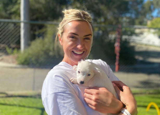 Ambassador Maeve Kavanagh headshot - holding a puppy in a yard