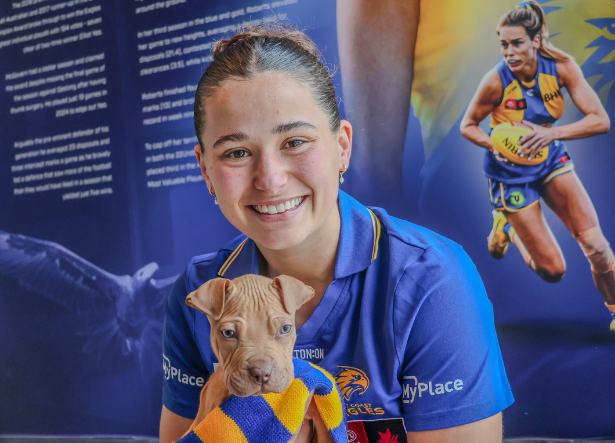 Ambassador Courtney Rowley AFLW headshot holding a puppy
