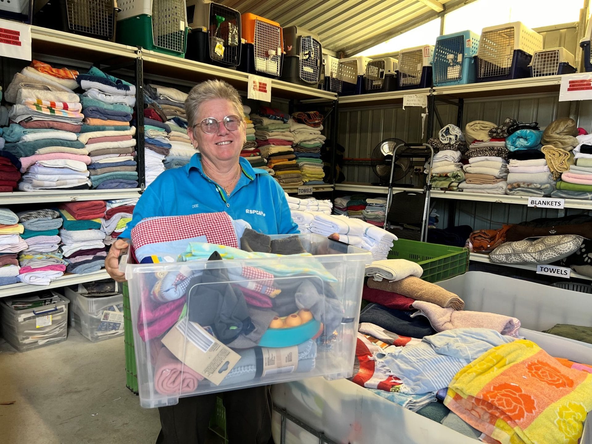 Dee, an RSPCA WA volunteer, organising donated blankets and other items at the RSPCA WA Animal Care Centre
