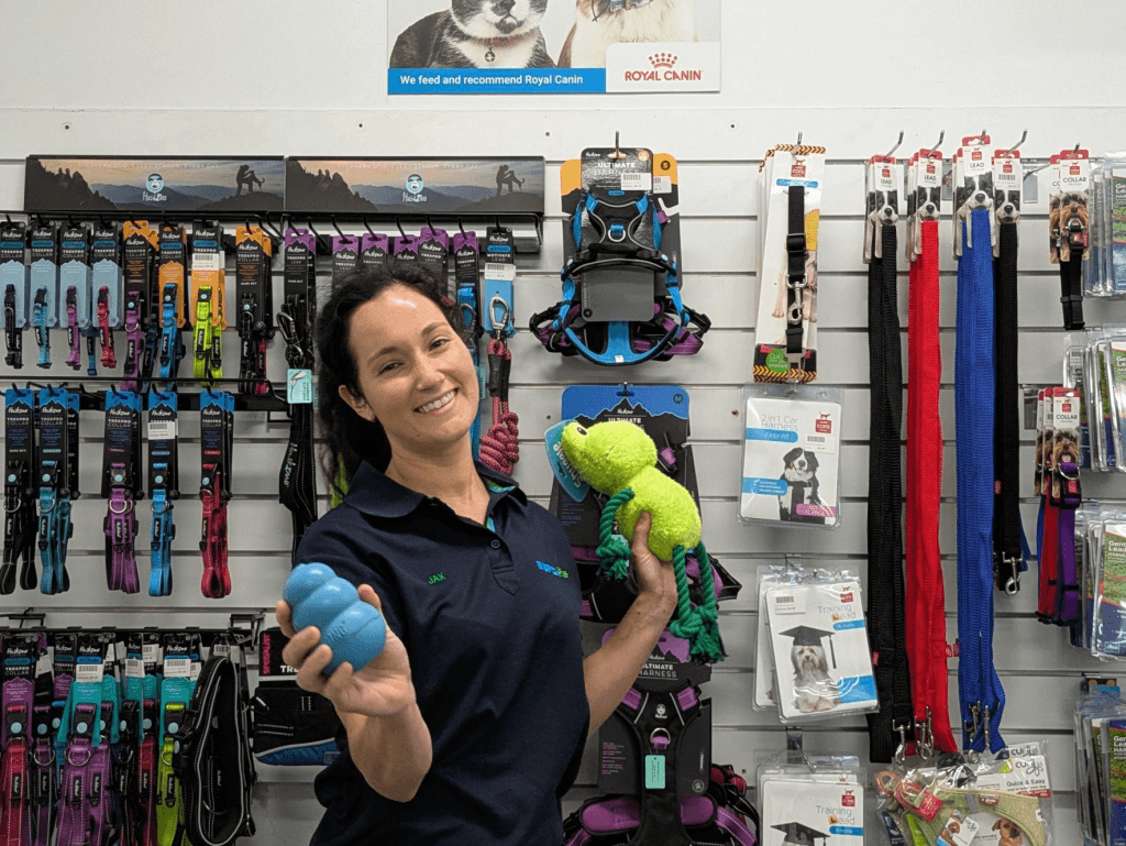 RSPCA Team Member Holding Dog Items at Retail Store