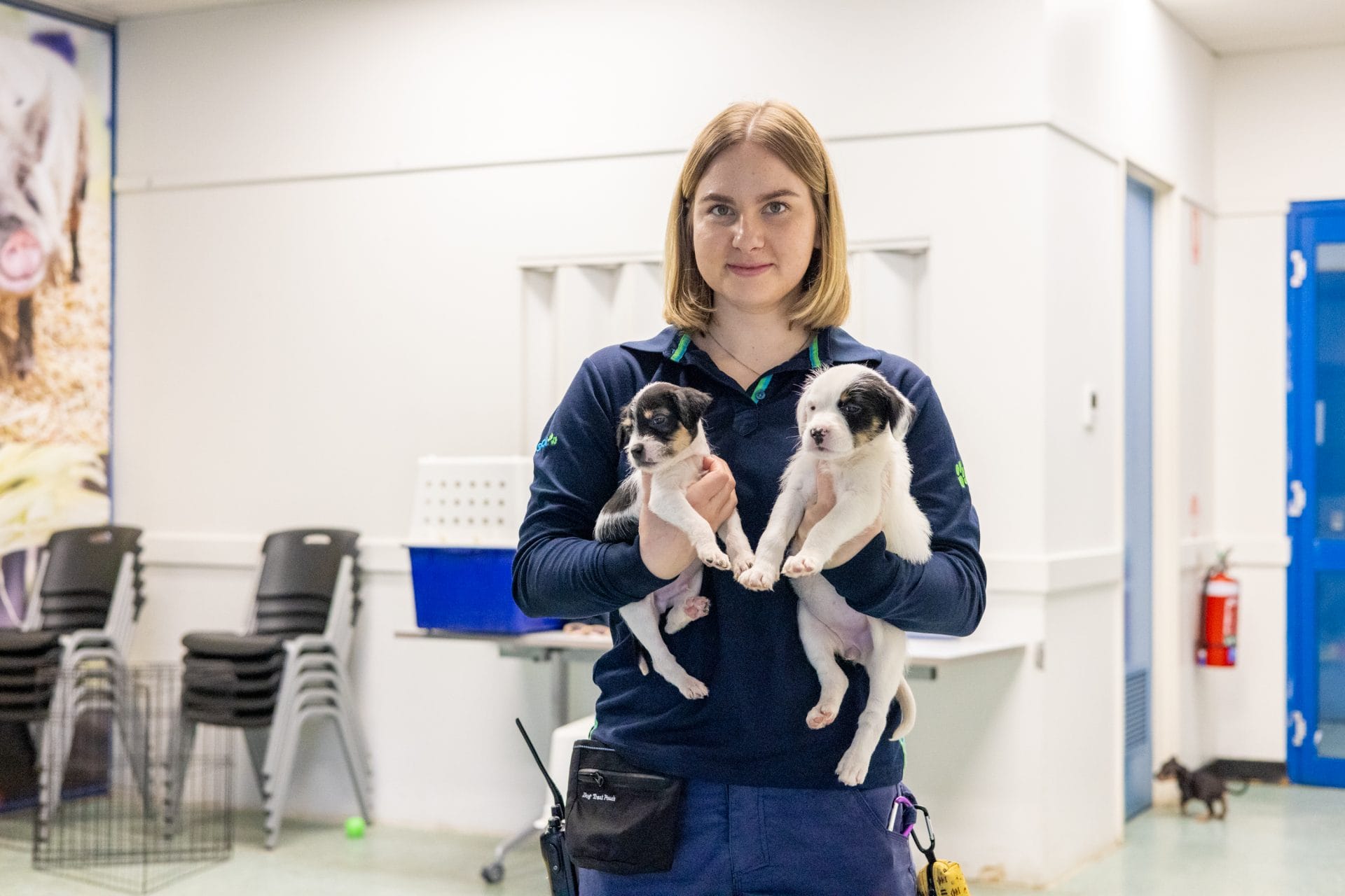 Emily Farrwll holding two puppies